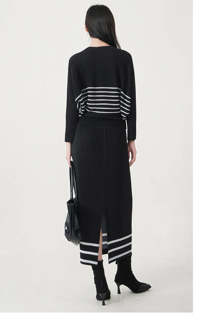 A trending women's clothing item for 2026: a matching black batwing-sleeved striped T-shirt and straight-cut skirt set by Miyake